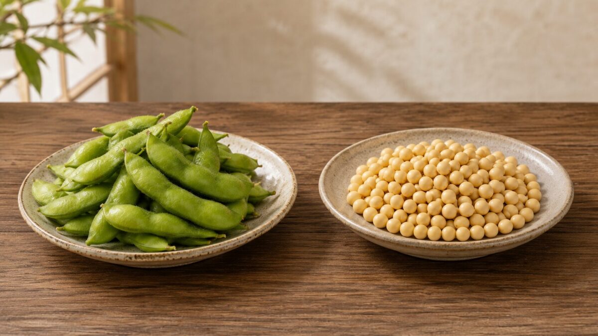 Green edamame pods and mature yellow soybeans displayed on separate plates