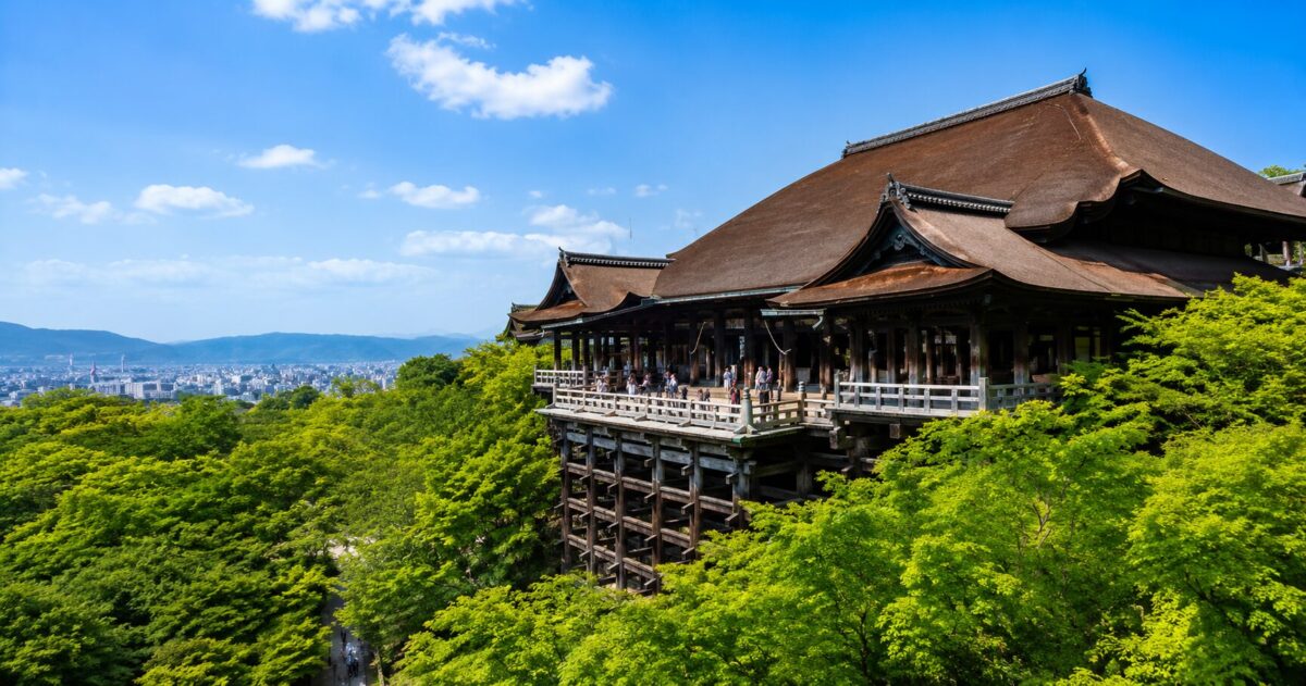 JA historic Japanese temple overlooking the city from a forested hillside