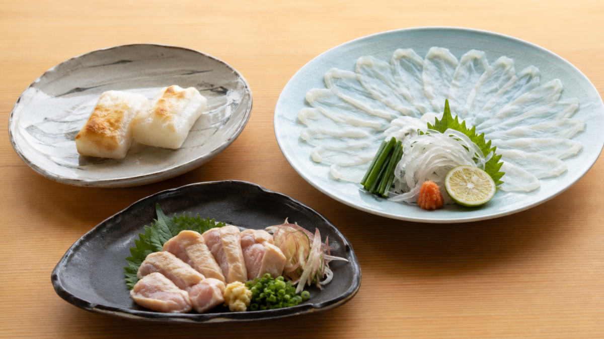 Mochi, prepared fugu sashimi, and a raw chicken dish representing foods that require genuine caution in Japan