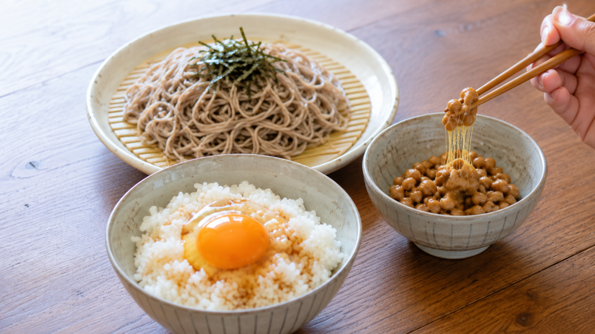 Natto, shirako, umeboshi, ika no shiokara, tororo, mozuku, raw egg, and soba representing surprising Japanese foods