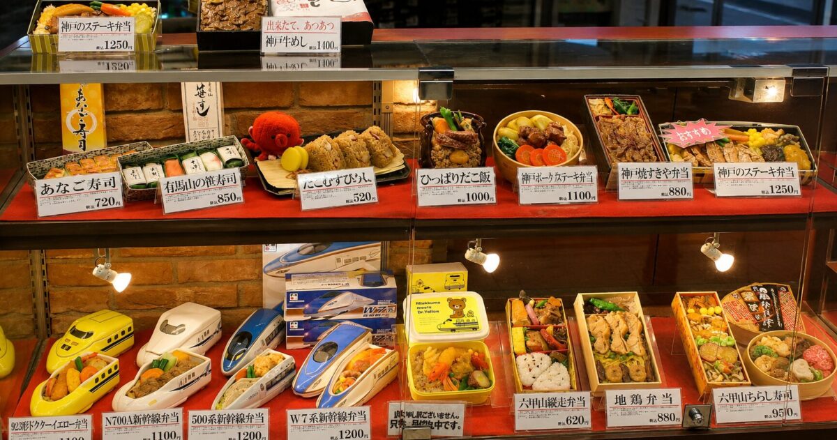 A display of ekiben lunch boxes for sale at a Shinkansen station in Japan.